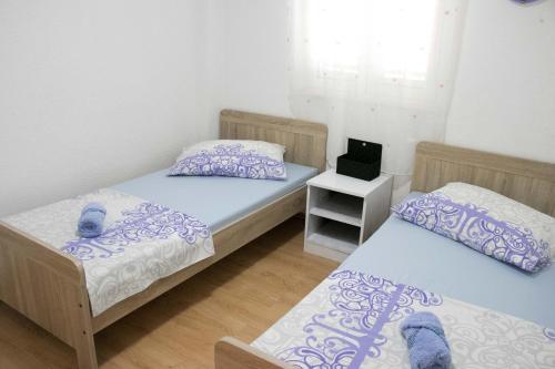 a room with two beds and a laptop on a table at Apartment Lorena in Sevid