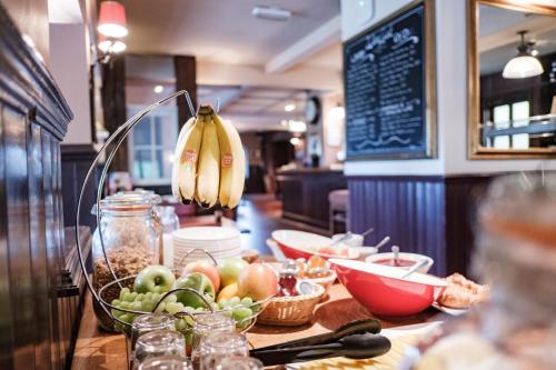 a table with a bowl of fruit and bananas on it at The Hampshire Hog in Clanfield