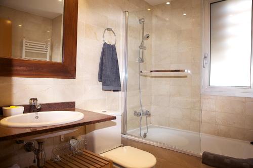 a bathroom with a sink and a shower and a toilet at Great Sea-Side Barcelona Apartment in Badalona