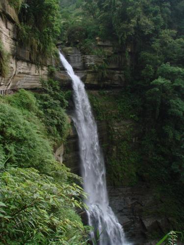 a waterfall on the side of a mountain at Gaodiyuan Tea B&B 高帝園茶業民宿 in Meishan