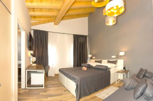 a bedroom with a bed and a couch in it at Aspalathos Residence in Split