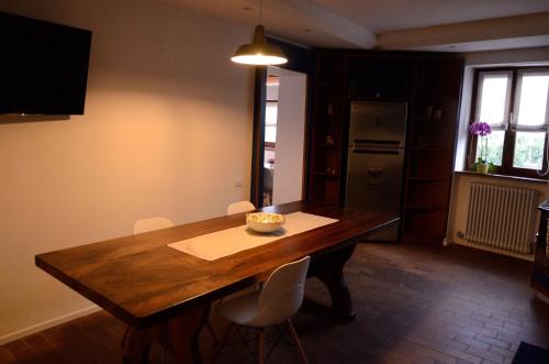 a dining room with a wooden table and chairs at Al Trifoglio in Campodenno