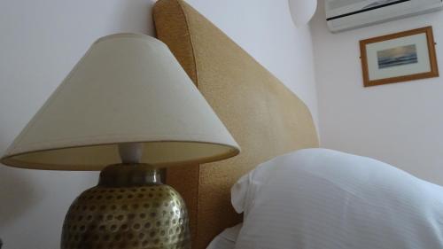 a lamp sitting next to a bed in a bedroom at The Furze Bush Inn in Newbury