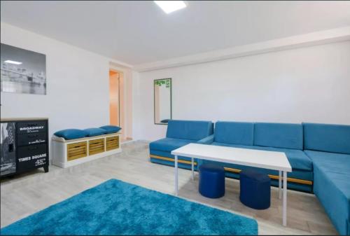 a living room with a blue couch and a table at Apartment Fontana in Belgrade