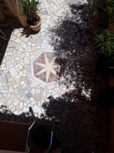a shadow of a plant on a patio at Krinelos Rooms in Skala Eresou