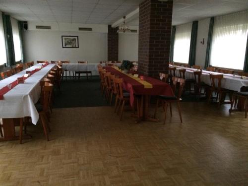 a dining room with tables and chairs in a building at Zur Krone in Seelze