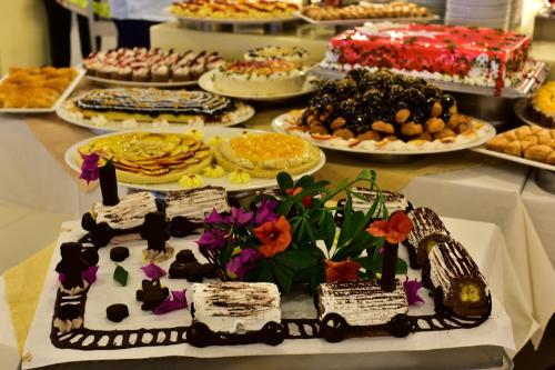 a table with many different types of cakes and desserts at Parkim Ayaz Hotel in Gümbet