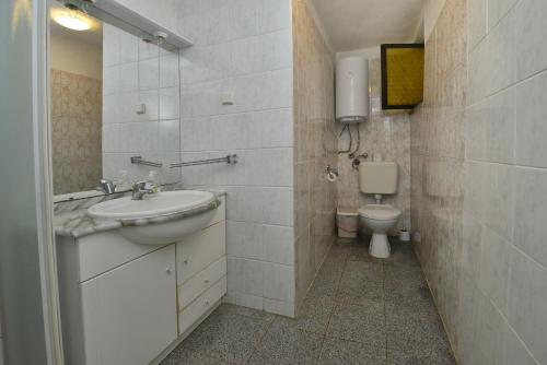 a bathroom with a sink and a toilet at Villa Funtana in Funtana