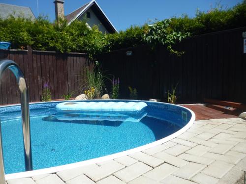 a small swimming pool in a yard at Pension Pugner in Vysoké nad Jizerou