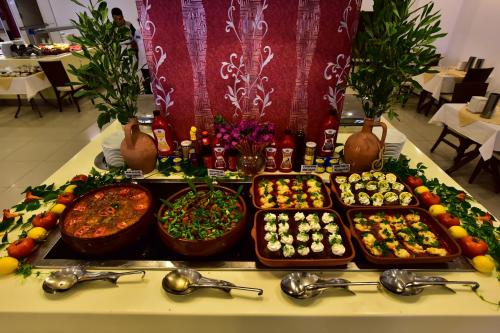 a buffet of different types of food on a table at Parkim Ayaz Hotel in Gümbet
