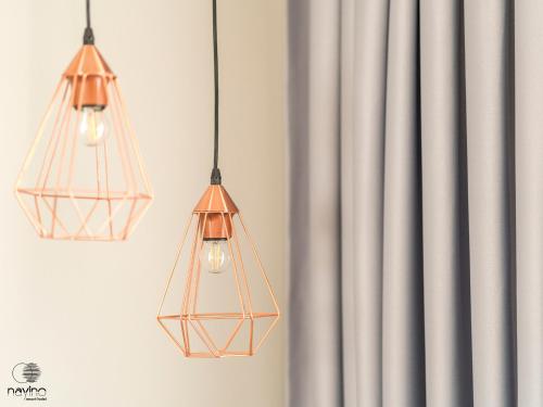 two lights hanging from a wall next to a curtain at Nayino Resort Hotel in Mamaia Nord