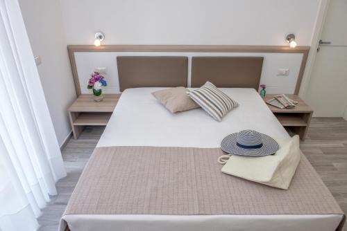 a bedroom with a large bed with two hats on it at A un passo dal mare in Vieste