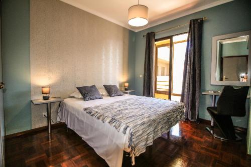 a bedroom with a bed and a large window at Our Dream Downtown Experience by AnaLodges in Funchal