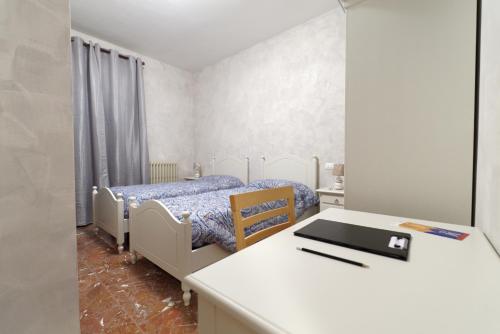a bedroom with a bed and a desk with a laptop at B&B Arwen in Ponte San Giovanni