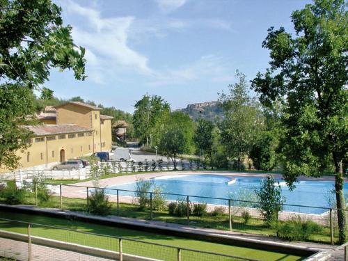 a large swimming pool in front of a building at House Roberto by Holiday World in Castel del Piano