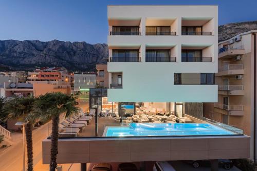 a view of a building with a swimming pool at Boutique Hotel Ani - Adults Only in Makarska