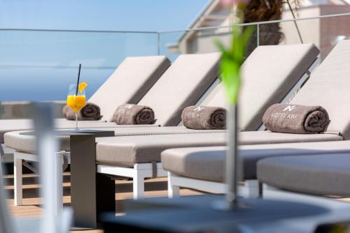 a row of white chairs with a drink on them at Boutique Hotel Ani - Adults Only in Makarska