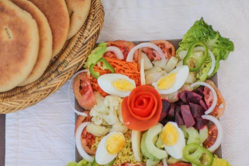 a basket of food with eggs and vegetables on it at Kasbah Africa - High Atlas Dark Sky & Nature Lodge in Ouirgane