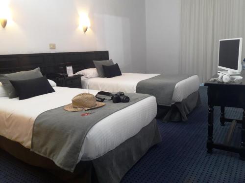 Postel nebo postele na pokoji v ubytování Hotel Miramar