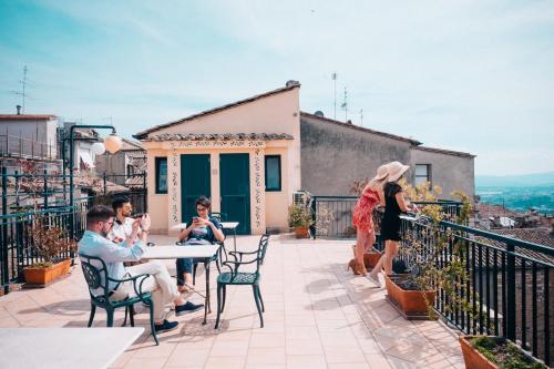 a group of people sitting at a table on a balcony at Hotel Fortuna in Perugia