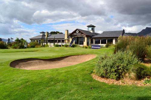a golf course with a house in the background at Pearl Valley-Golf Safari SA in Paarl