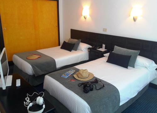 Postel nebo postele na pokoji v ubytování Hotel Miramar