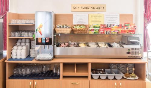 a kitchen with a counter with food and drinks at City-Inn in Prague
