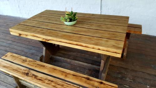 a wooden table with a potted plant sitting on it at Bella Manga Country Escape in Plettenberg Bay