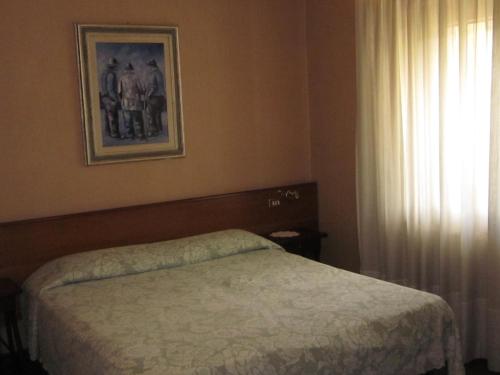 A bed or beds in a room at Hotel Casale