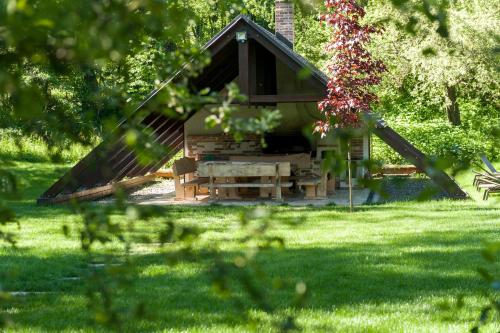 a small cabin in a park with green grass at Chalet Hovel in Mănăstirea Humorului