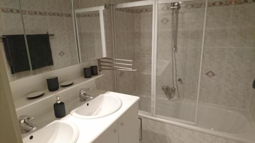 a bathroom with a sink and a shower at SeaWind in Middelkerke