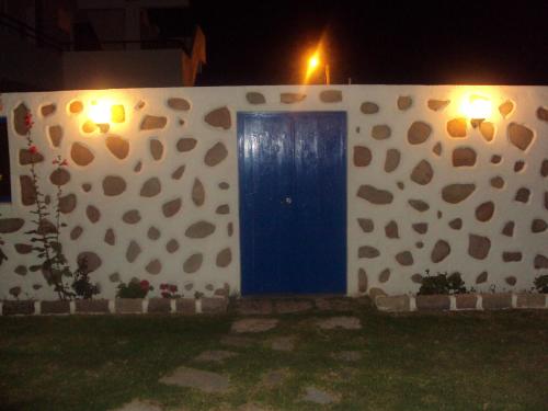 a blue door in the side of a wall at Al Mare Apartments in Afantou