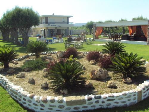 a garden with trees and plants in a yard at Al Mare Apartments in Afantou