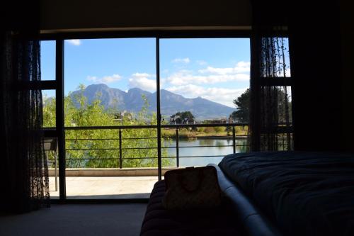 a bedroom with a large window with a view at Pearl Valley-Golf Safari SA in Paarl
