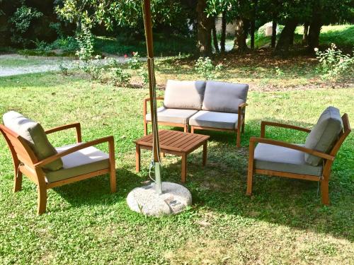 a group of chairs and a table and an umbrella at Palazzo Mantua Benavides Suites & Apartments in Padova