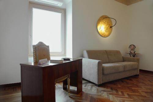 a living room with a couch and a table at Antica Civita Luxury Room in Matera