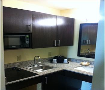 a kitchen with a sink and a microwave at Americas Best Value Inn Lake Charles Interstate 210 in Lake Charles