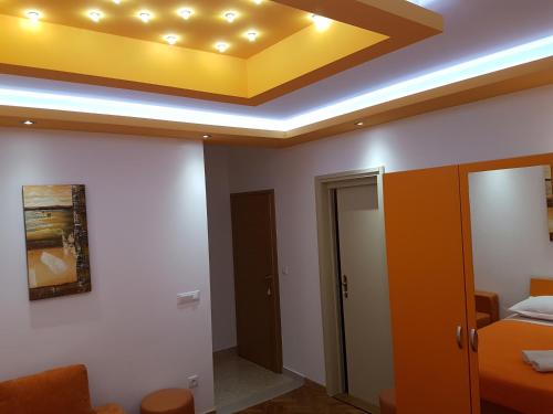 a room with a yellow ceiling and a bed at House Villa Roza in Tučepi