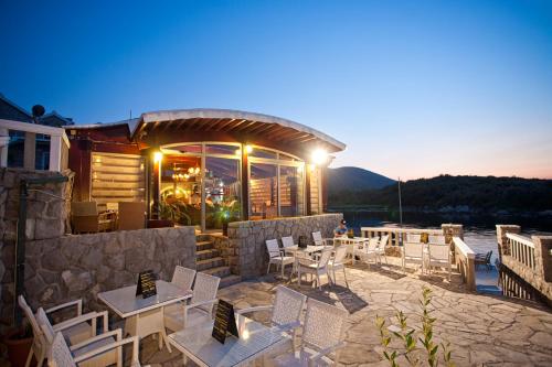 a restaurant with tables and chairs on a patio at Luxury Sea Residence by Kristina in Tivat