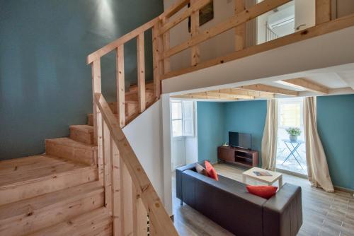 a living room with a loft bed and a couch at Borgo Apartments 1 & 2 Bedroom Self-Catering Units in Central Valletta in Valletta