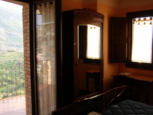 a bedroom with a bed and a window with a view at B&B Le Grazie in Piaggine