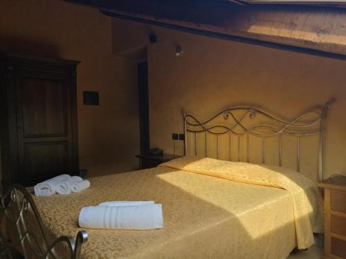 a bedroom with a bed with two towels on it at Residenza Il Duomo in Tropea