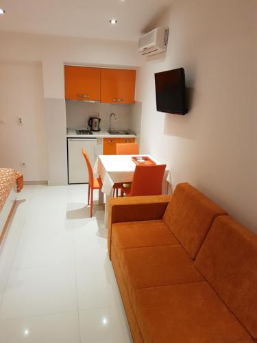 a living room with a couch and a table at House Villa Roza in Tučepi
