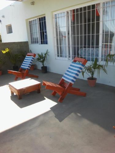 two lounge chairs and a table on a patio at Atardecer Serrano in Huerta Grande