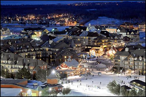 a town with a lot of buildings in the snow at Mountain Side Condo Loft at The Blue Mountains in Blue Mountains