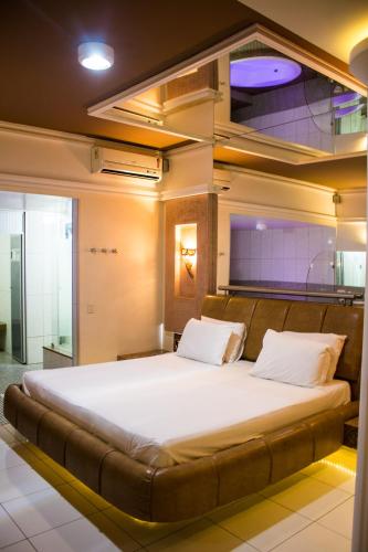 a bedroom with a large bed in a room at Netuno Motel (Adults Only) in Fortaleza