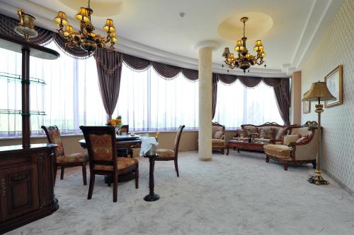 a living room filled with furniture and a large window at Park Hotel Stara Zagora in Stara Zagora