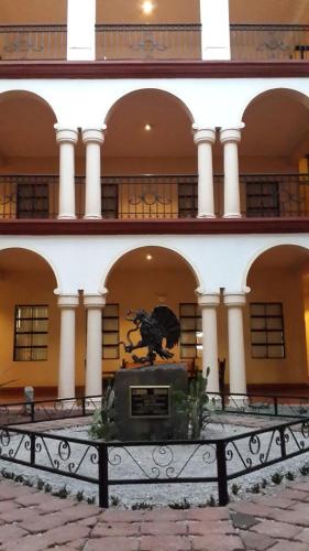 a building with a statue in front of it at Hotel Los Monteros in Ciudad Victoria
