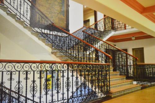 a set of stairs in a house with wrought iron railings at Hotel Los Monteros in Ciudad Victoria