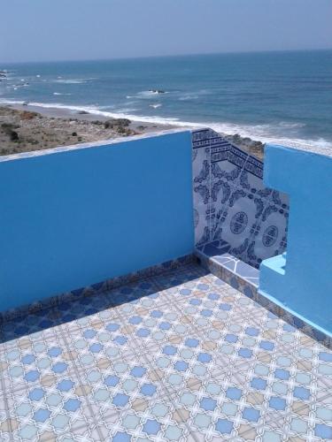 a blue wall with a view of the ocean at Beach House in Asilah